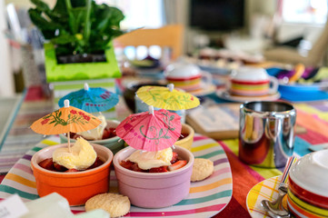 home made cakes on a table with cocktail umbrellas