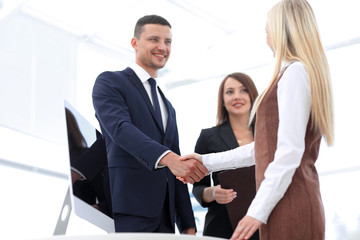 business colleagues shaking hands after a successful presentation.