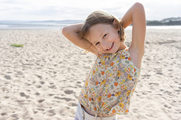 Portrait of a female child smiling and happy on the beach