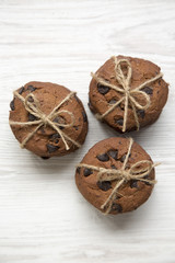 Chocolate chip cookies on a white wooden surface, overhead. Top view. Close-up.