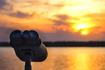 binoculars at the sunset