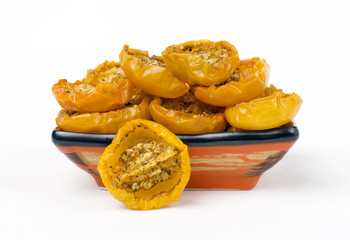 Bowl of dried yellow tomatoes on white background