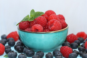 Raspberries and blueberries in a bowl.