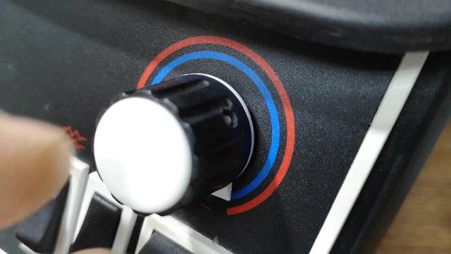 close up of hand rotates dimmer