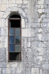 Fototapeta na wymiar Old beautiful Windows in a large stone house.