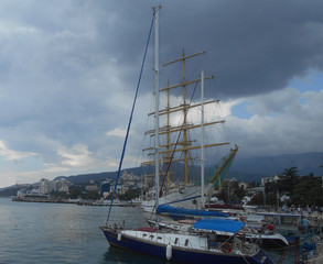 in the summer on the coast of the blue sea is a ship sailboat for boat trips