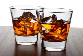 Glasses of Whiskey and Ice on Wooden Table
