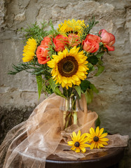 Beautiful floral bouquet in a atmospheric scenery on the old wall background.