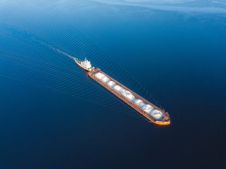 Aerial view carrier ship on river Volga. Cargo ship photo from drone.