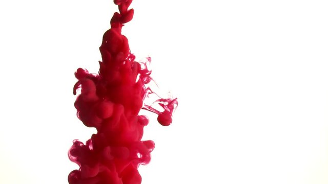 Red ink splash in water slow motion on white