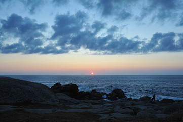 Fototapeta premium MUXIA, Galicia, Spain - July 18, 2018: sunset on the ocean, Costa da Morte, at the end of the Camino de Santiago