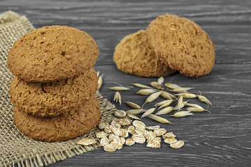 Oatmeal cookies with oatmeal and oatmeal seeds on a wooden background