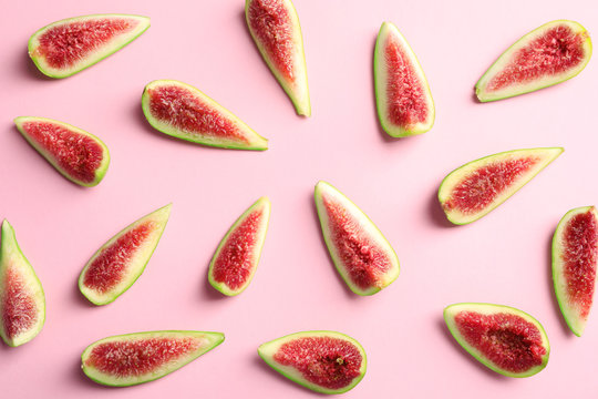 Fresh ripe fig slices on color background, top view