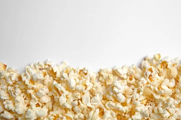 Gordijnen Delicious fresh popcorn on white background, top view © New Africa