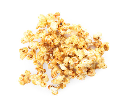 Pile of delicious caramel popcorn on white background, top view