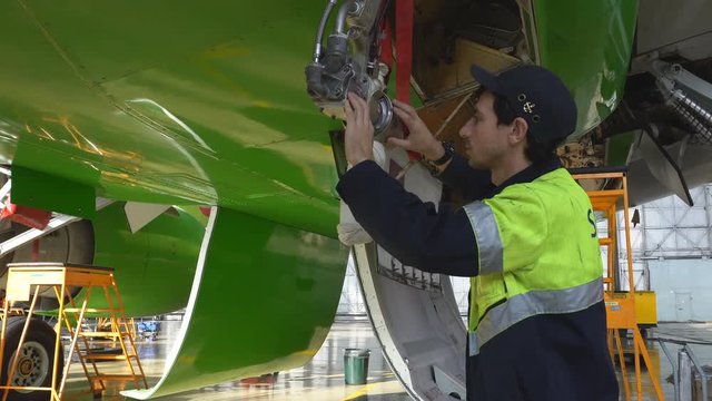 Aircraft service, view of the tail of the aircraft. Repair of an airplane wing white 4k.