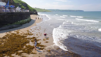 Children playing in the sea, in Whitby, on a beautiful summer day.