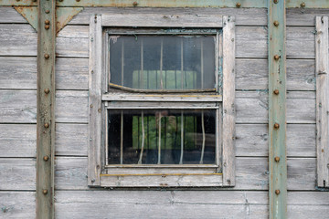 Fototapeta na wymiar Old window in a railway wagon. Narrow-gauge railway wagon on the siding.