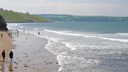 Families enjoying the beach and paddling in the sea during the British heatwave of 2018.