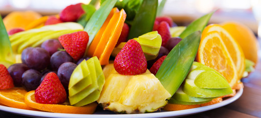 Party plate with fresh fruit cuts on table