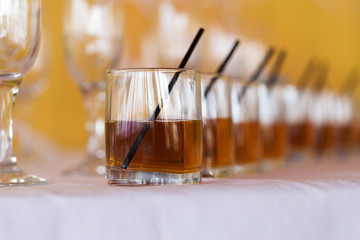 Row of whiskey and cognac on table