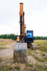 Fototapeta na wymiar Yellow construct transport excavator digging earth outdoors
