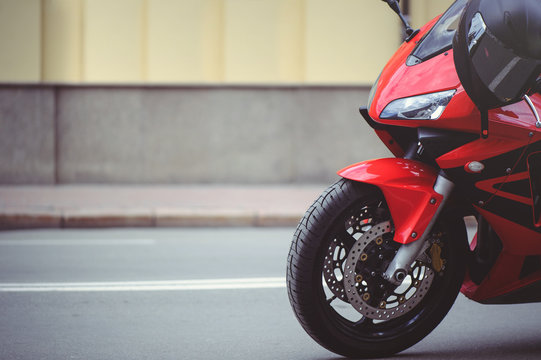 sports red motorcycle in the city, place for text