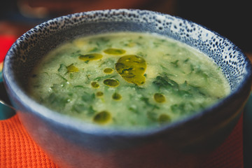 View of Caldo Verde, a popular soup in Portuguese cuisine, traditional portuguese soup with potatoes, collard greens, olive oil and salt.