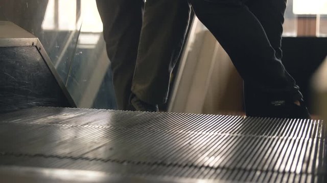 Close Up View Of Moving Escalator With People Standing