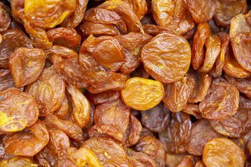 Dried apricots texture in shop close up.