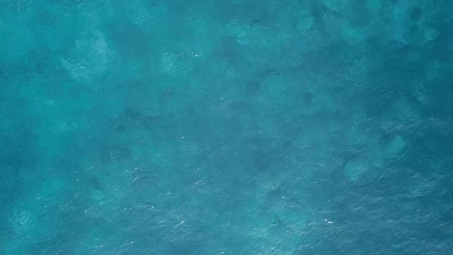 Drone aerial view of blue sea surface.