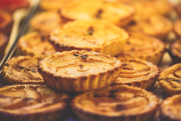 Traditional Portuguese egg tart pasty cakes, dessert Pasteis de nata with different portuguese pastry on the cafe store window, pastel de nata