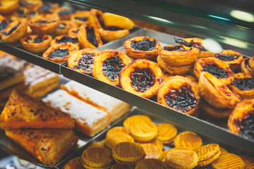 Traditional Portuguese egg tart pasty cakes, dessert Pasteis de nata with different portuguese...