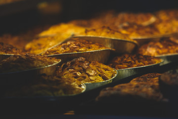 Traditional Portuguese egg tart pasty cakes, dessert Pasteis de nata with different portuguese pastry on the cafe store window, pastel de nata