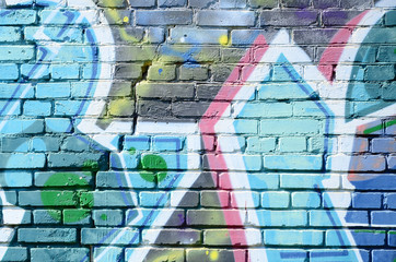 Fragment of graffiti drawings. The old wall decorated with paint stains in the style of street art culture. Colored background texture in cold tones