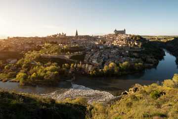 Panoramic view of the medieval center of the city of Toledo, Spain. It features the Tejo river, the Cathedral and Alcazar of Toledo, Spain..
