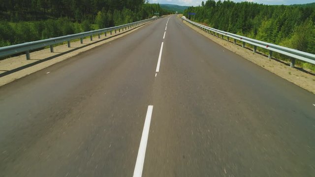 Flying over the empty road. Aerial view 4 k