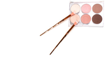 isolated bronze makeup eye brushes kit mint blue with skin powder top view on white