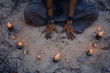 woman with candle deep in forest. Witch craft concept