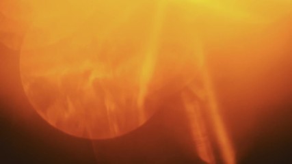 Beautiful orange light leaks in warm hue on dark background.