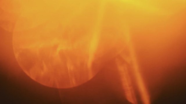 Beautiful orange light leaks in warm hue on dark background.