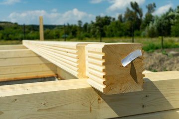 Construction of a wooden house made of profiled laminated veneer lumber. Bookmark corners.