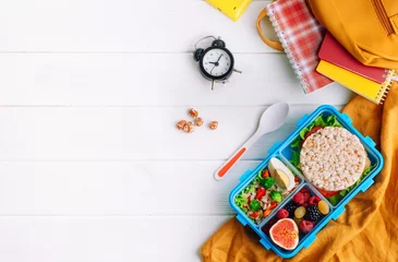 Foto op Plexiglas Lunch box on white wooden background near school accessories © lithiumphoto