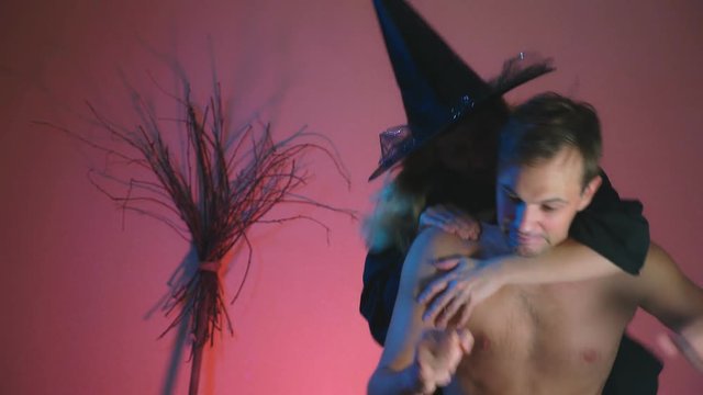 on the dancing man, during the celebration of Halloween, the vampire attacks and bites him in the neck, blood flows through his body. 4k, slow motion