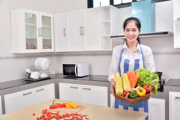 Pregnant woman cutting vegetables in the kitchen Portrait of woman chef mixing eggs in dish preparing vegetable 
