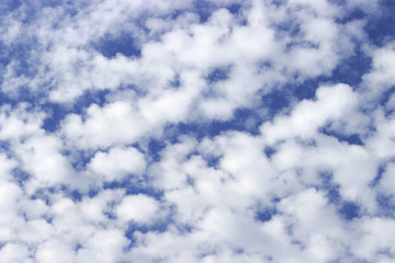 White fluffy clouds in the blue sky close up, texture, background