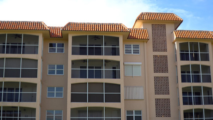 Day time exterior of generic apartment or condominium building facade on beautiful summer day in tropical geographic location
