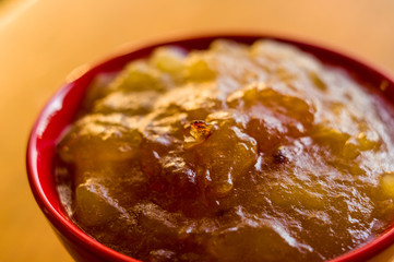 Homemade apple jamTransparent Apple sweet homemade jam in the red ceramic bowl