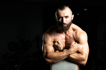Fototapeta na wymiar Beard Man Showing His Well Trained Biceps