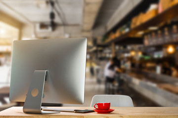 workspace with desktop computer, office supplies, houseplant and coffee cup at office. desk work concept.